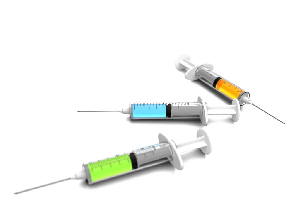 Three syringes with colored liquid