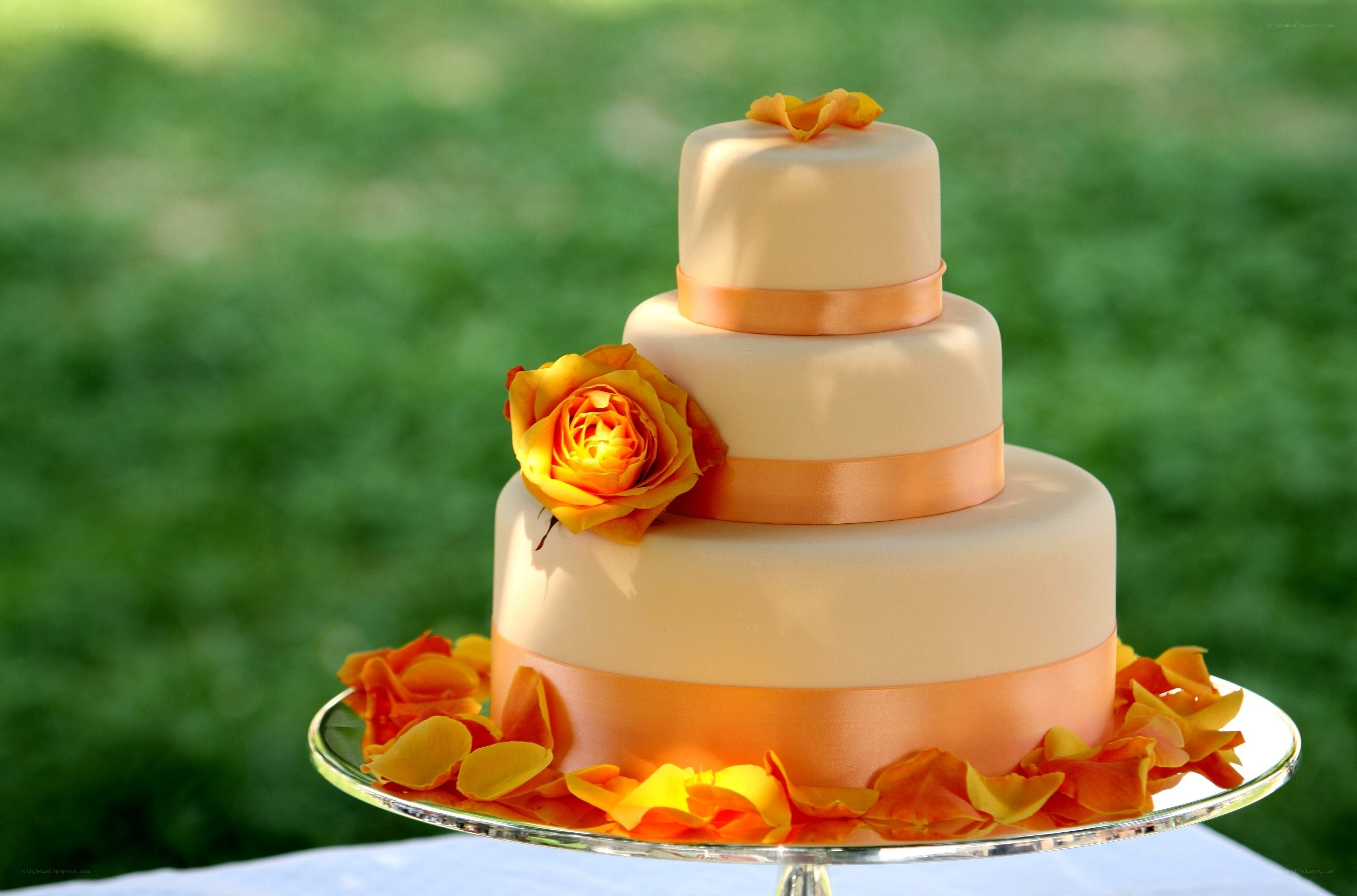 Three-tiered wedding cake with orange flowers