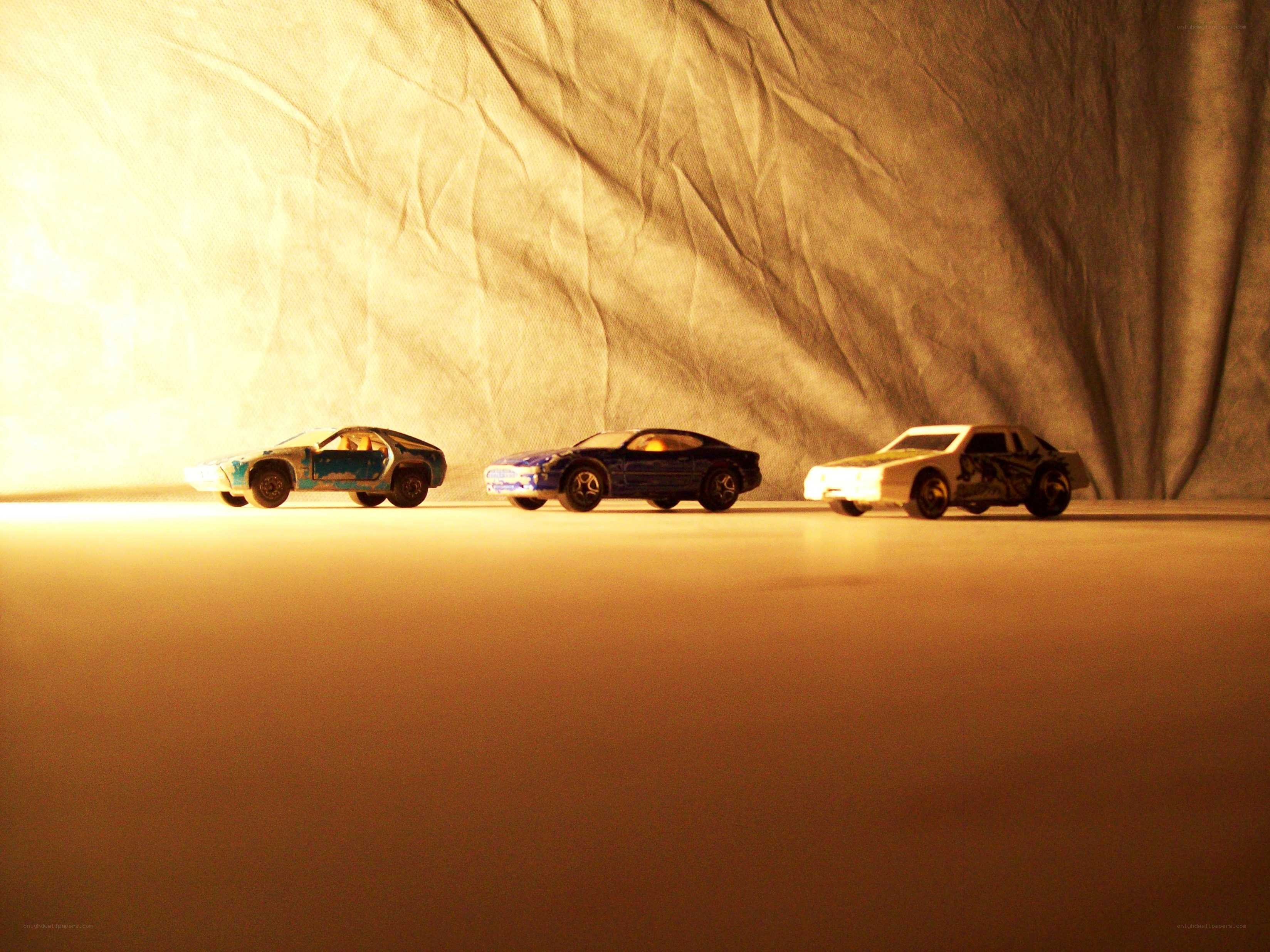 three toy cars on a surface