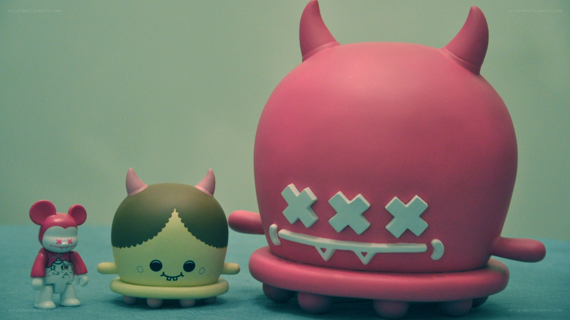 Three toy figures in a row