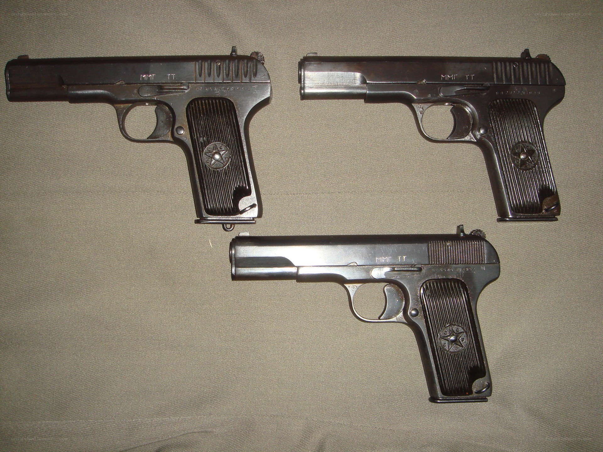 Three TT pistols on fabric