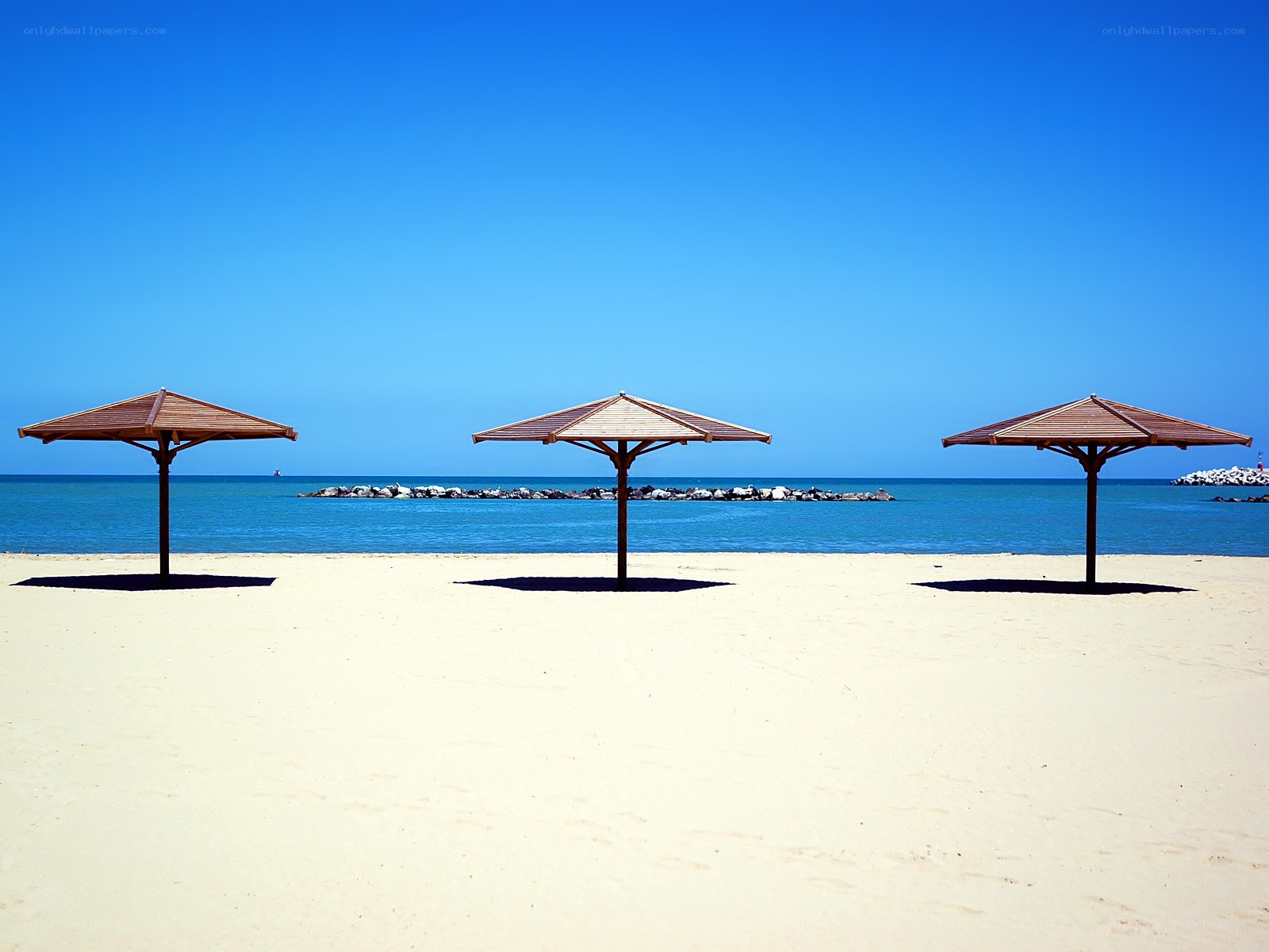 Three umbrellas on a sunny beach