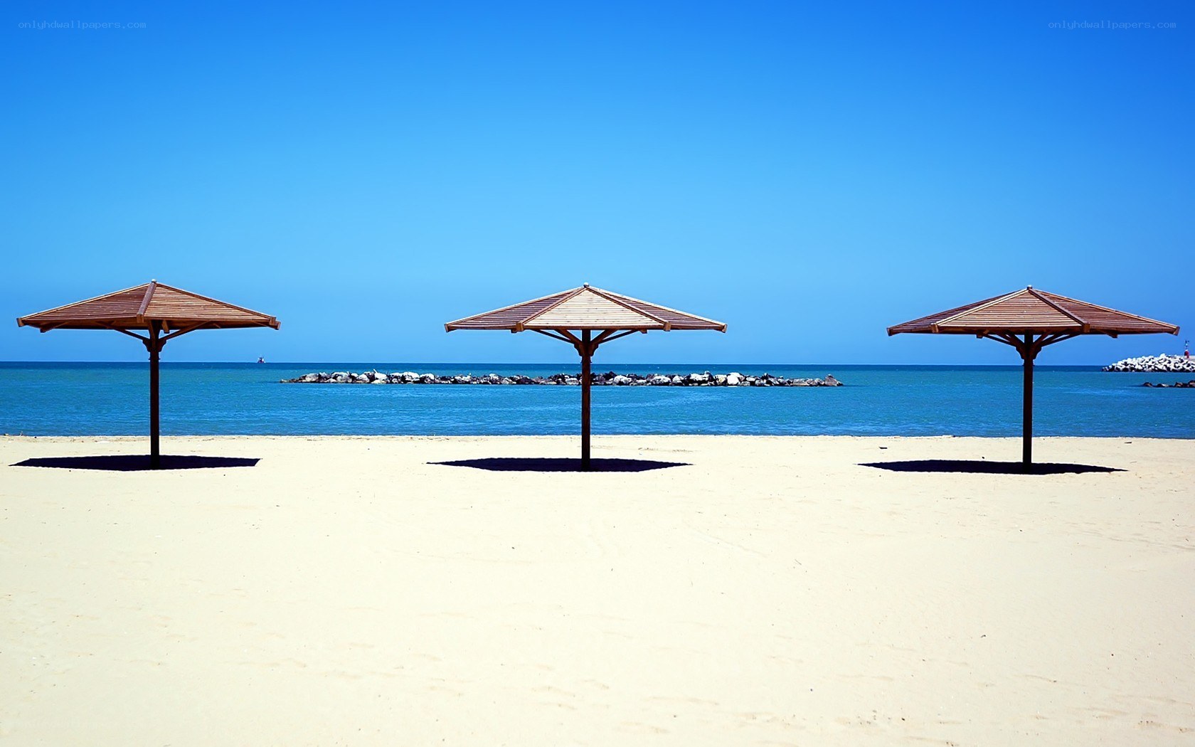 Three umbrellas on a sunny beach