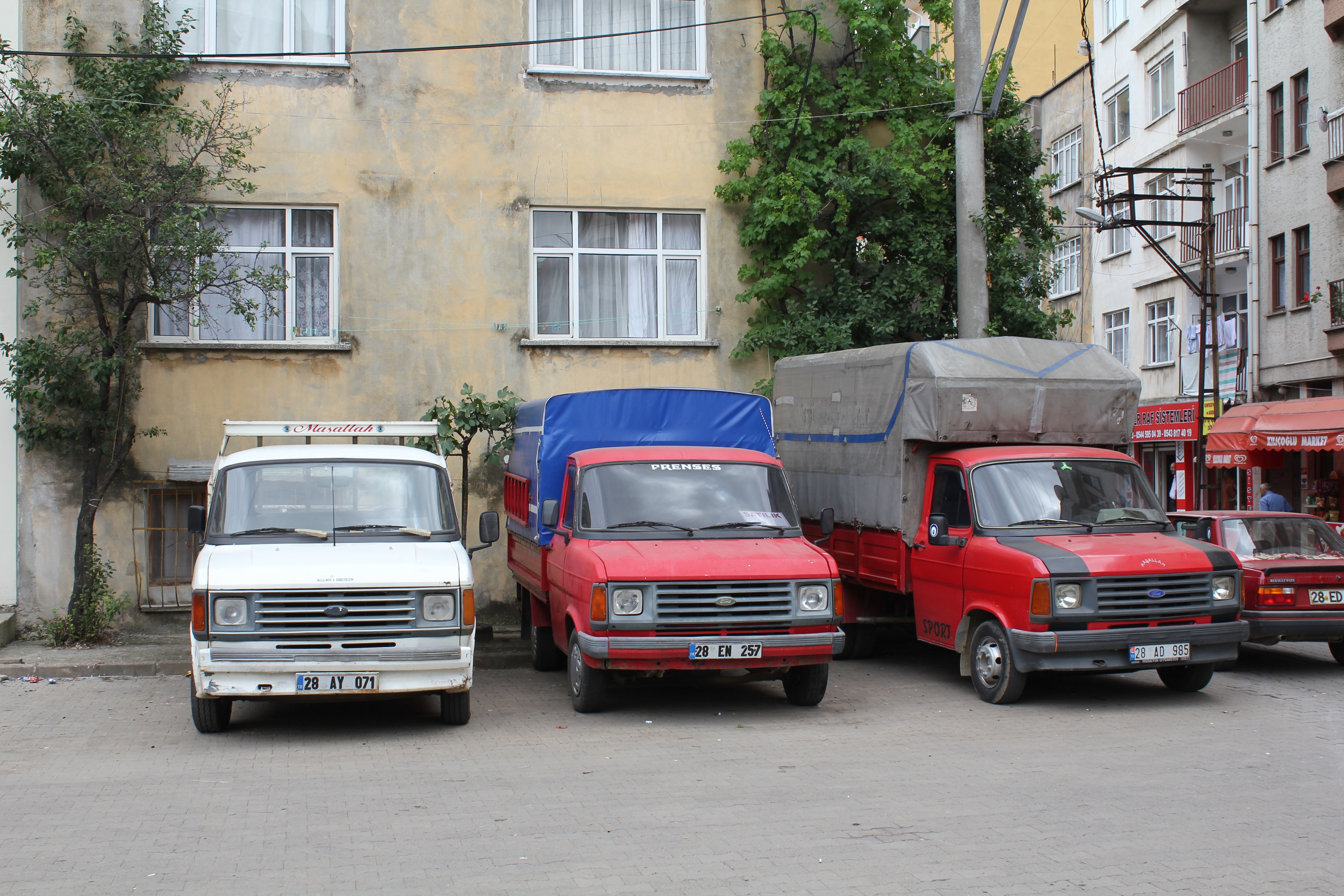 Three vans parked on a street