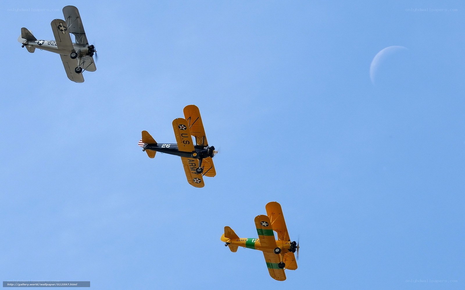 Three vintage biplanes in flight
