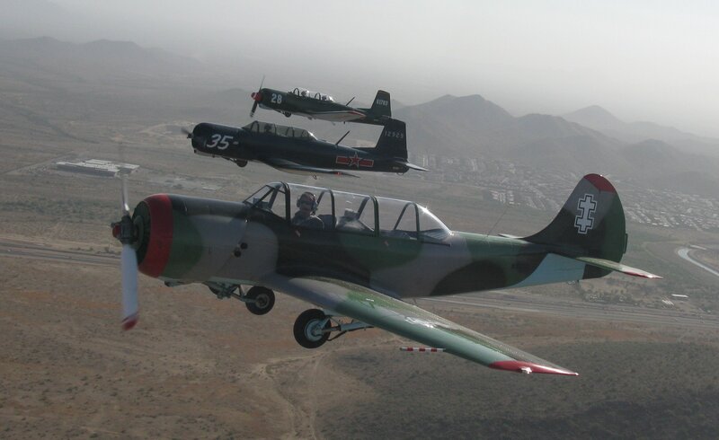 Three vintage military planes in flight