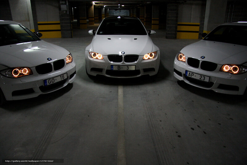 Three white BMWs in garage