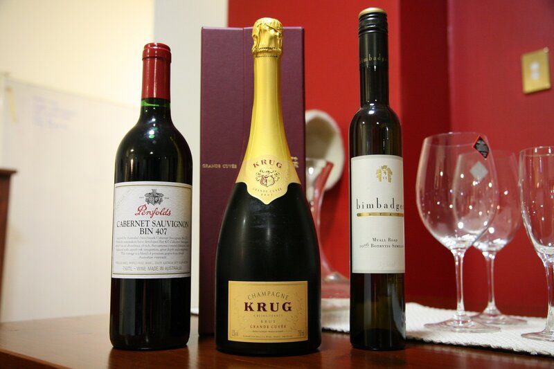 Three wine bottles on a table