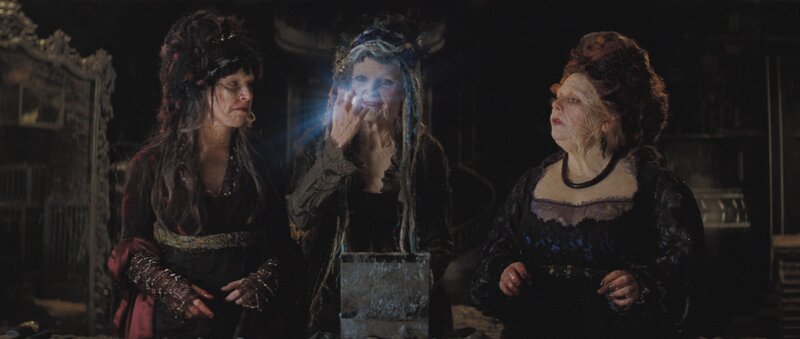 three witches in a dark room