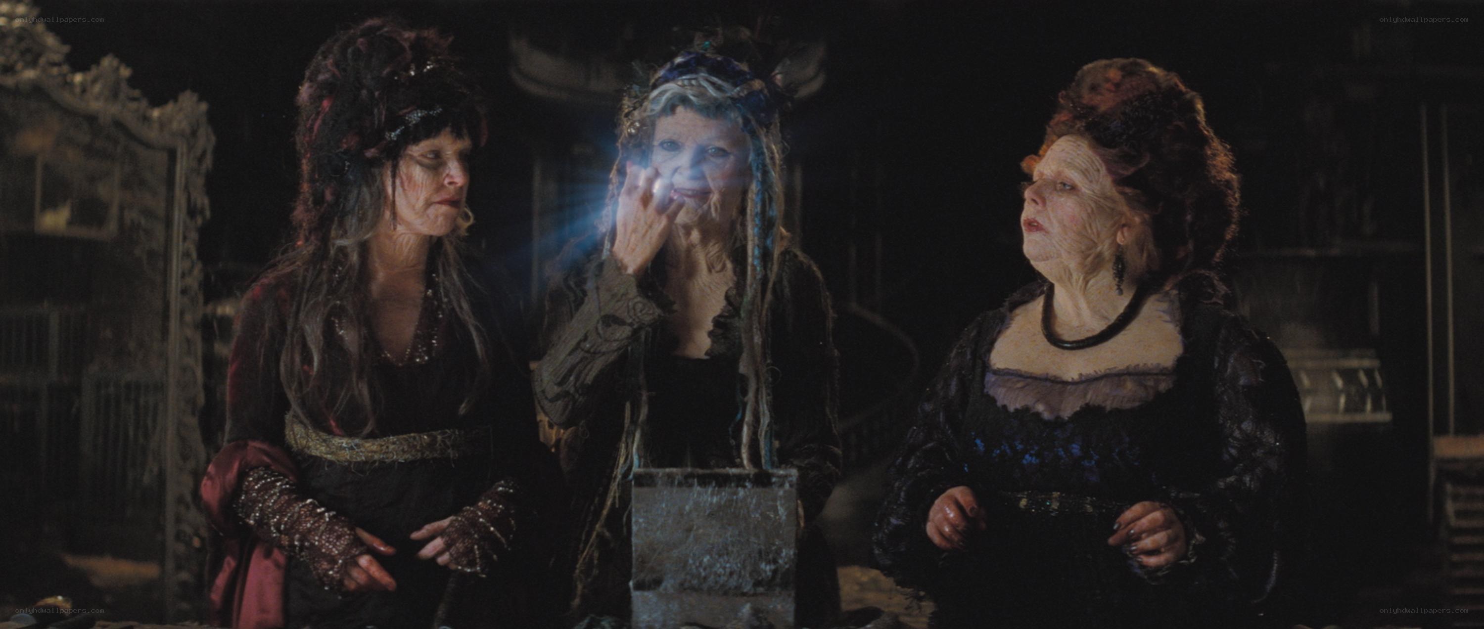 three witches in a dark room