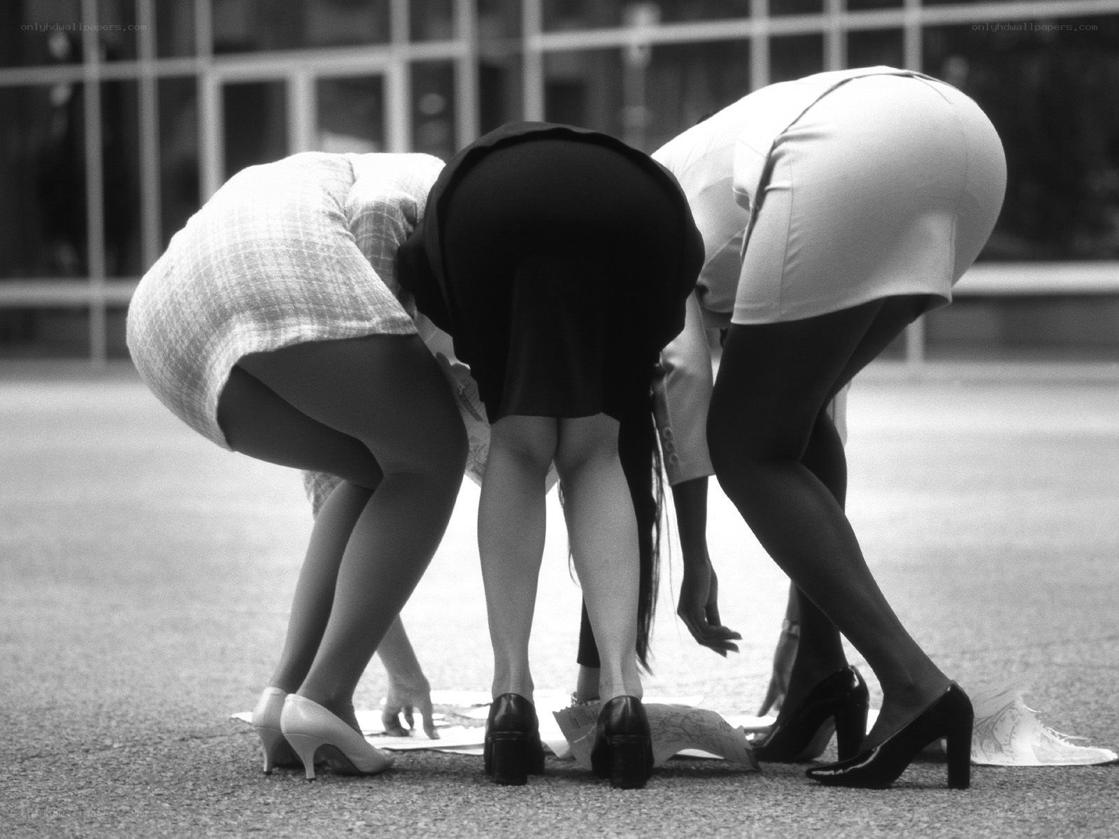 Three women bending over