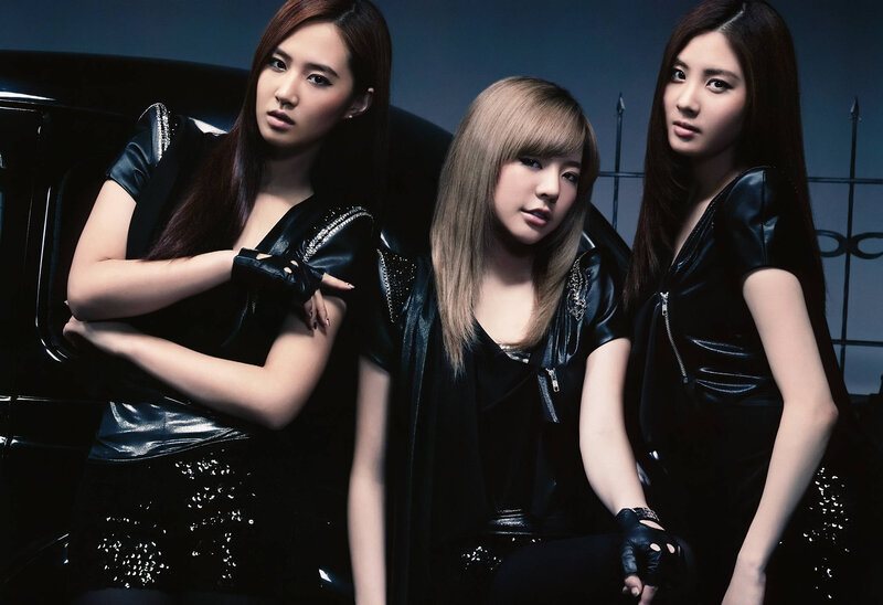 three women in black leather outfits