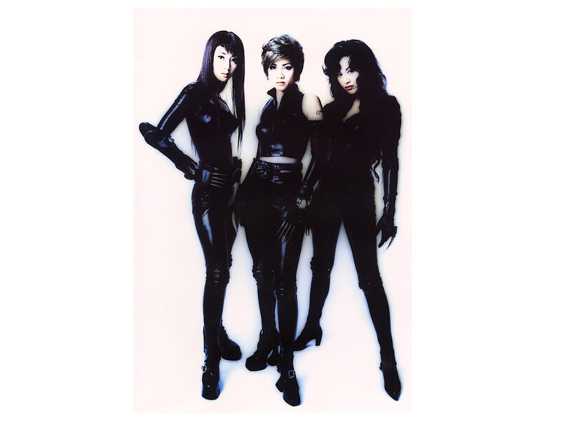 three women in black leather outfits