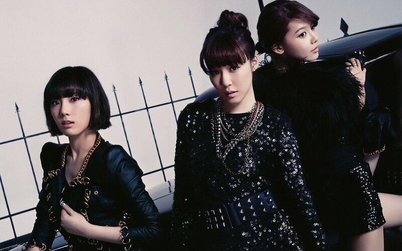 three women in black outfits