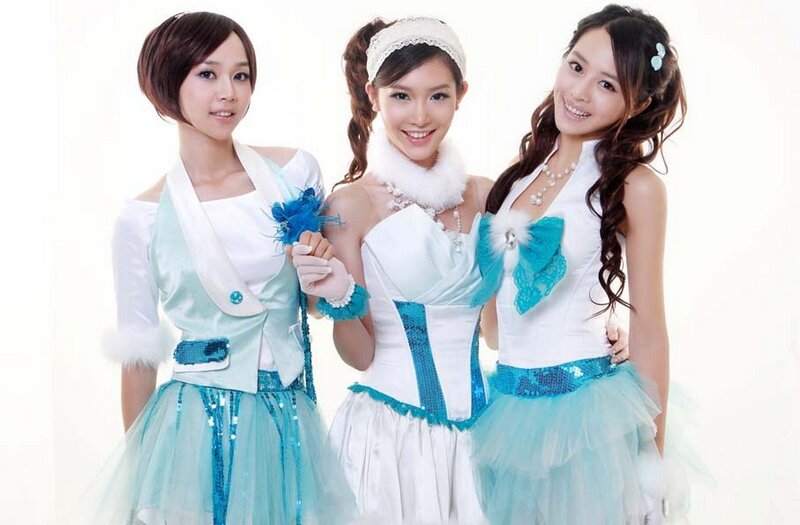 three women in blue and white costumes