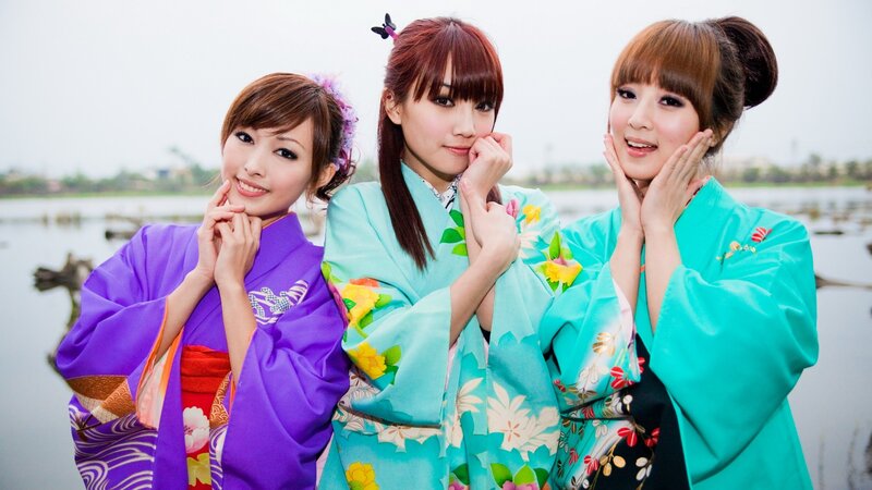 Three women in colorful kimonos