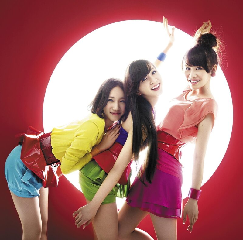 Three women in colorful outfits
