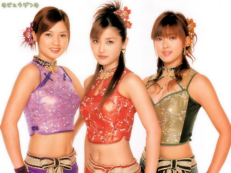 three women in colorful outfits