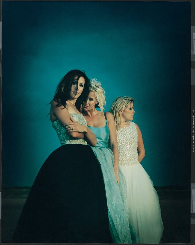 three women in elegant gowns