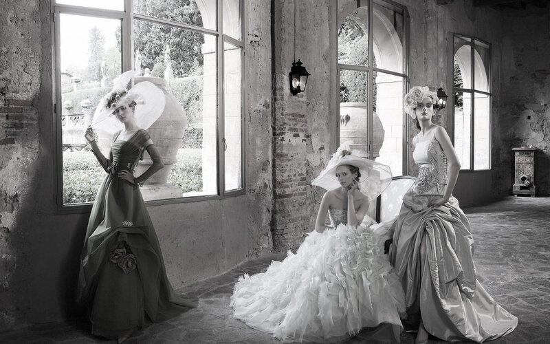 Three women in elegant gowns