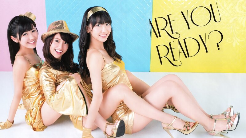 three women in gold outfits
