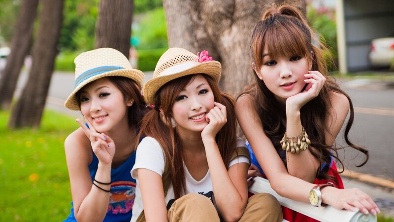 three women in hats smiling