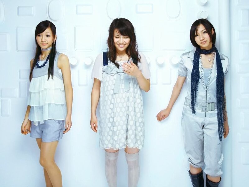 three women in light-colored outfits