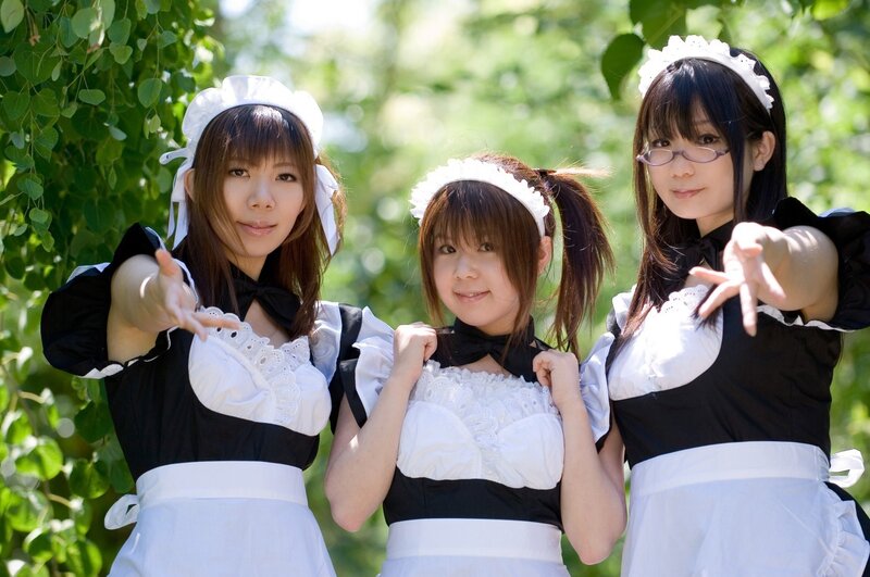 Three women in maid costumes