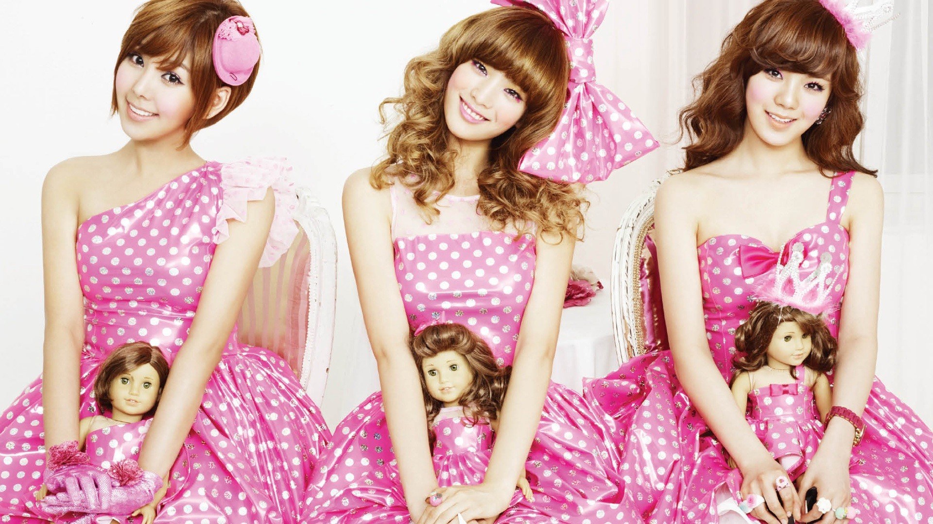 three women in pink dresses