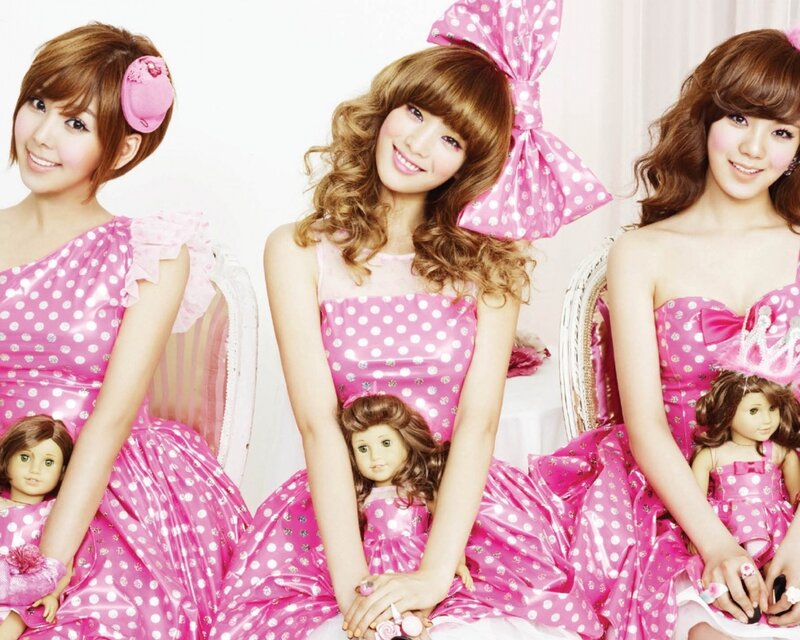 Three women in pink polka-dot dresses
