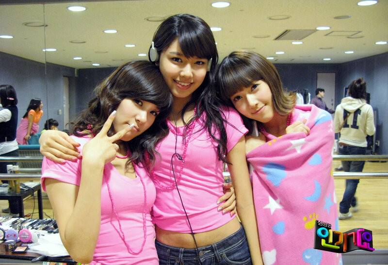 Three women in pink posing together