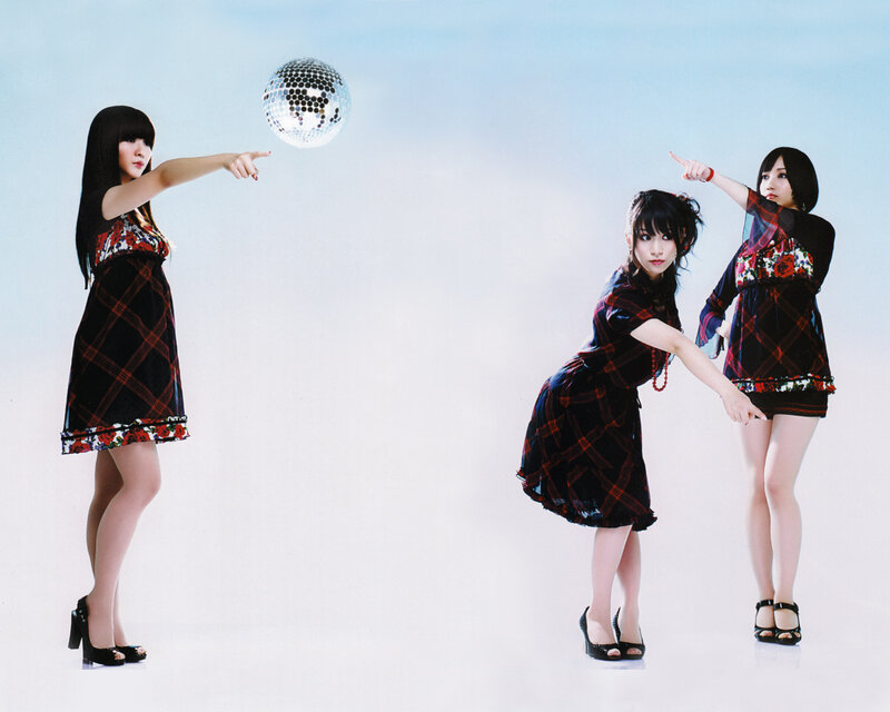 Three women in plaid dresses with disco ball