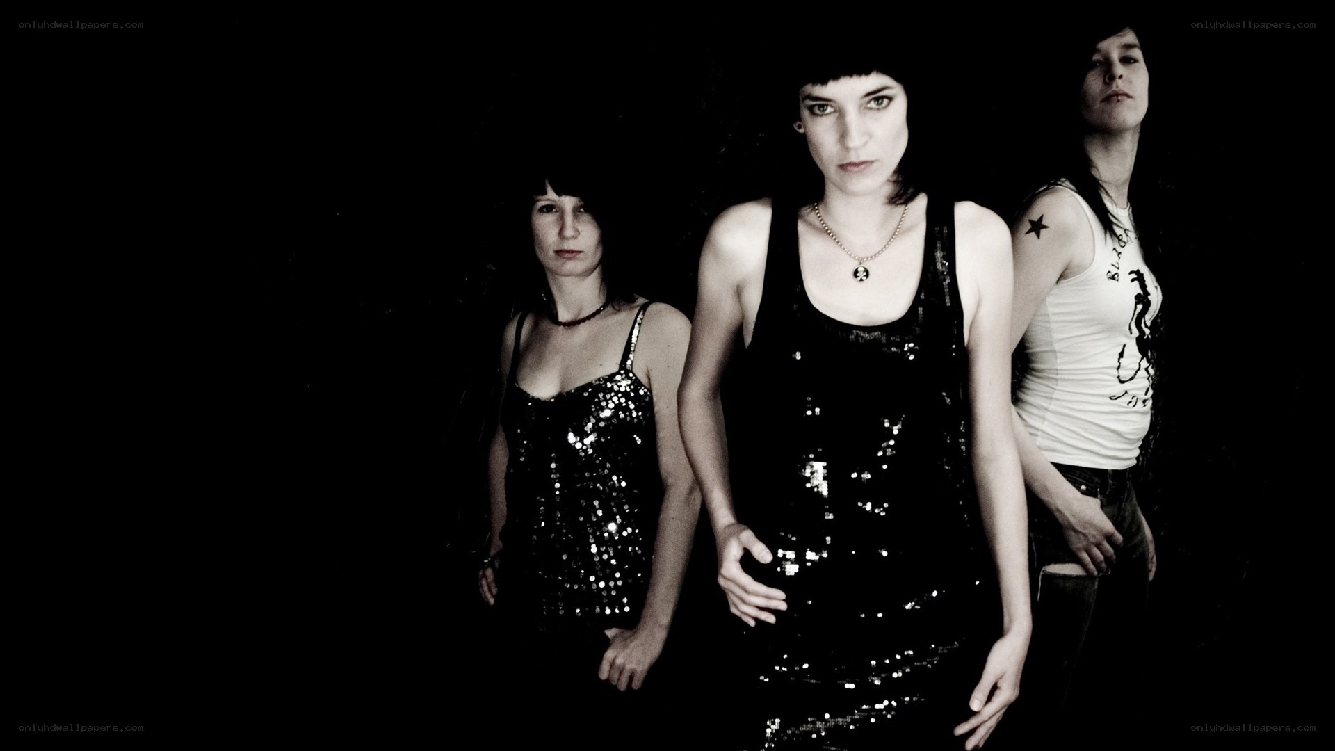 three women in sequined tops