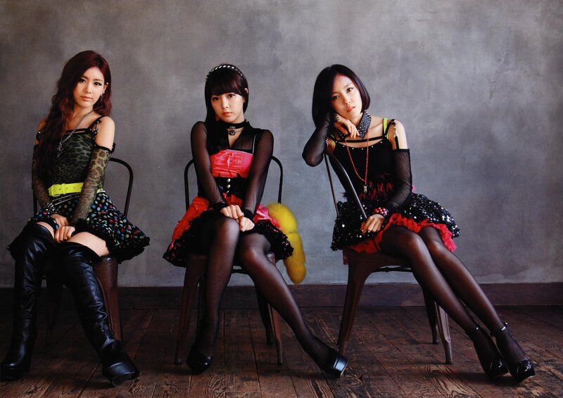 three women in stylish outfits