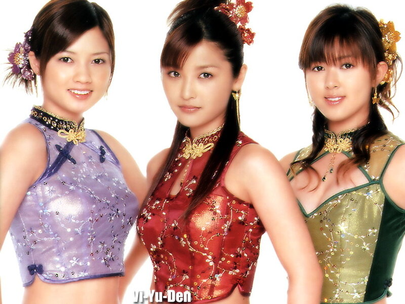 Three women in traditional-inspired outfits