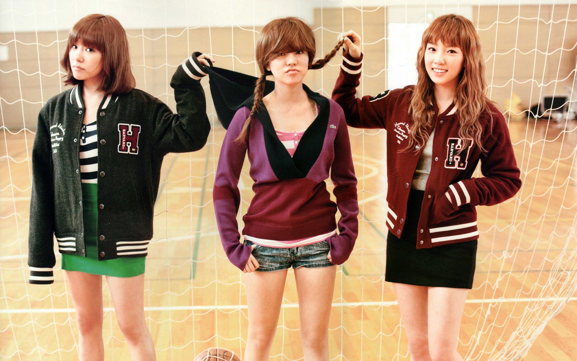 Three women in varsity jackets