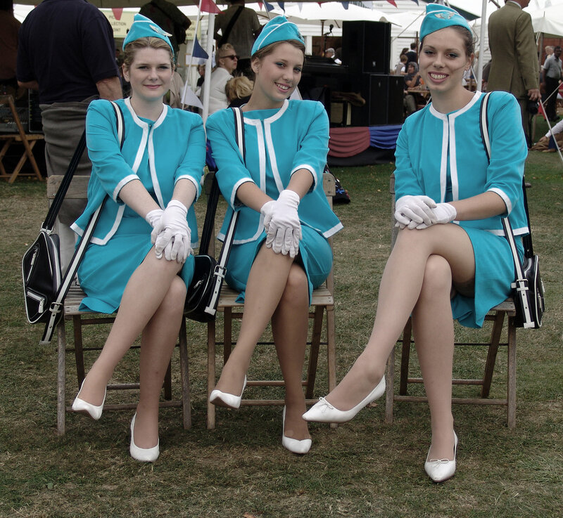 Three women in vintage flight attendant uniforms