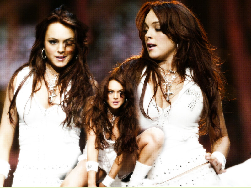 three women in white on stage