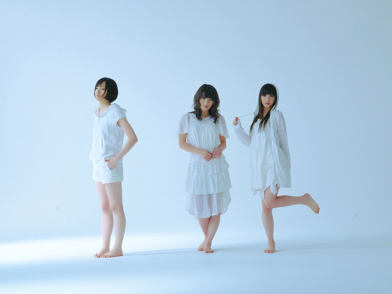 Three women in white outfits