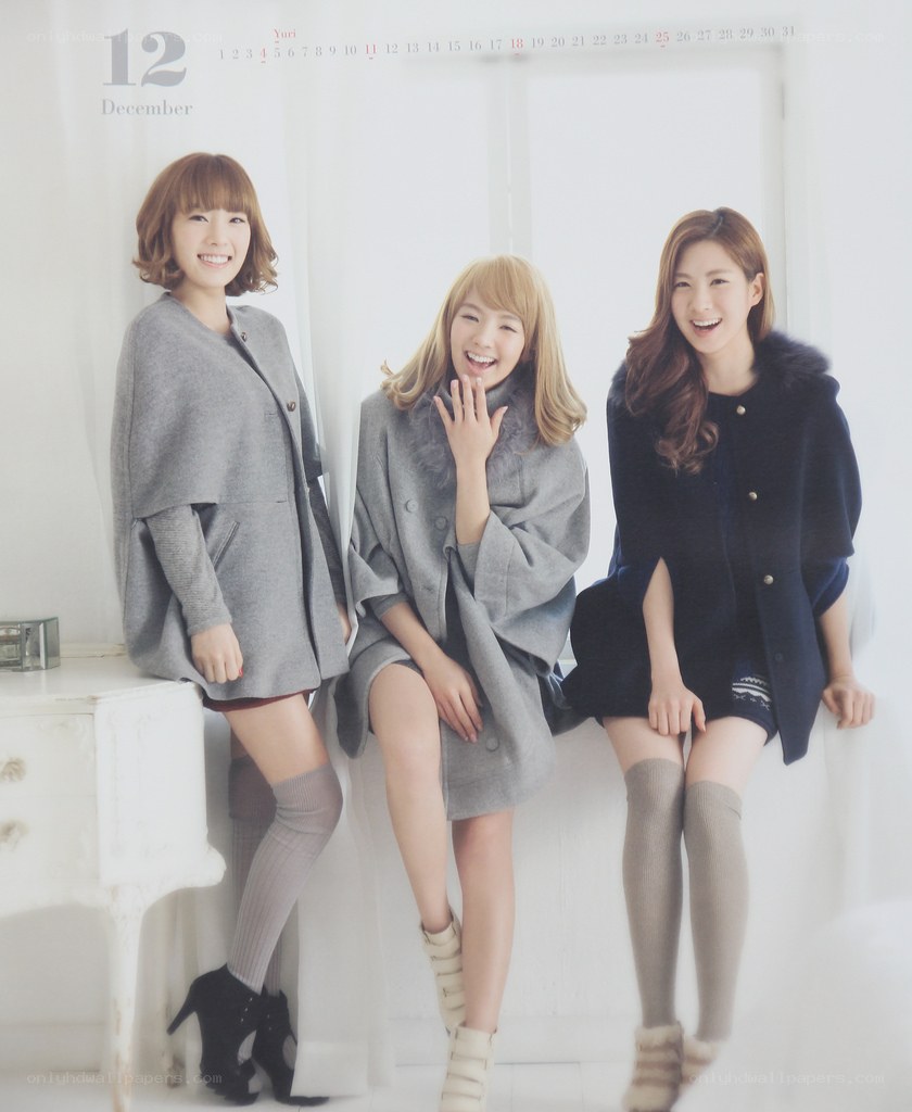 three women in winter coats