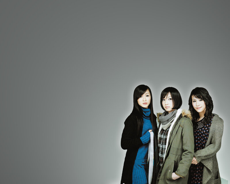 three women in winter coats