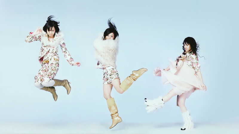 three women jumping in floral outfits