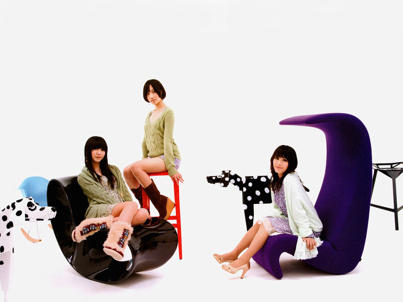 three women on colorful chairs