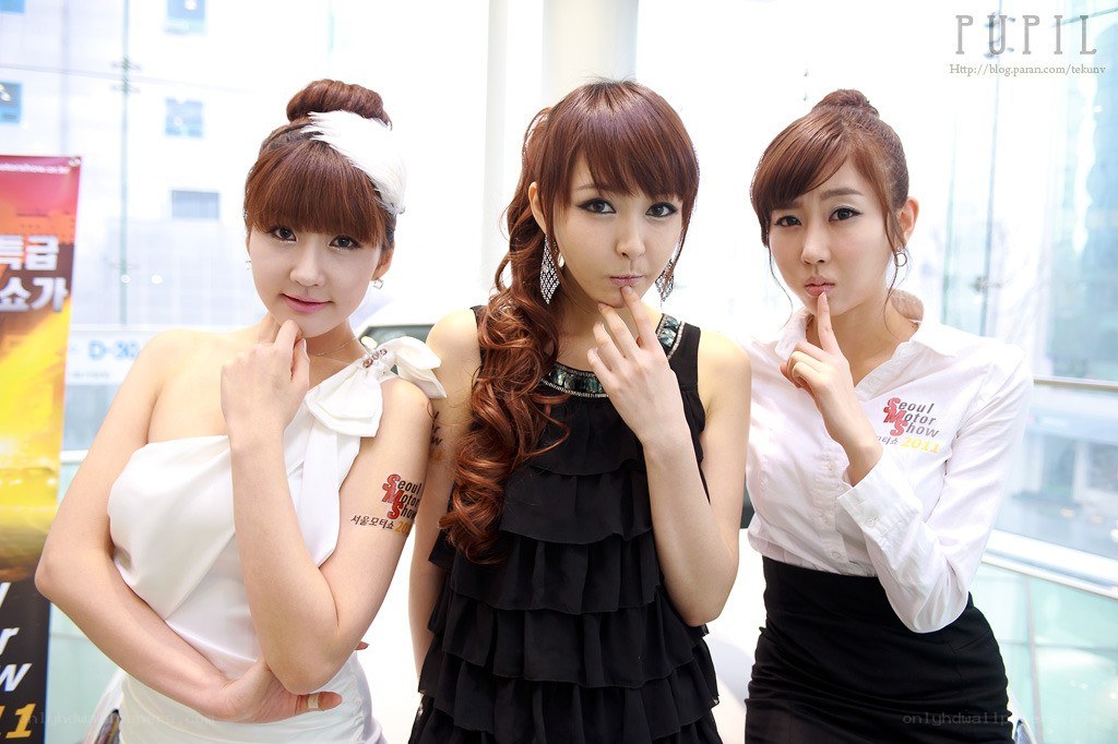 three women posing at event