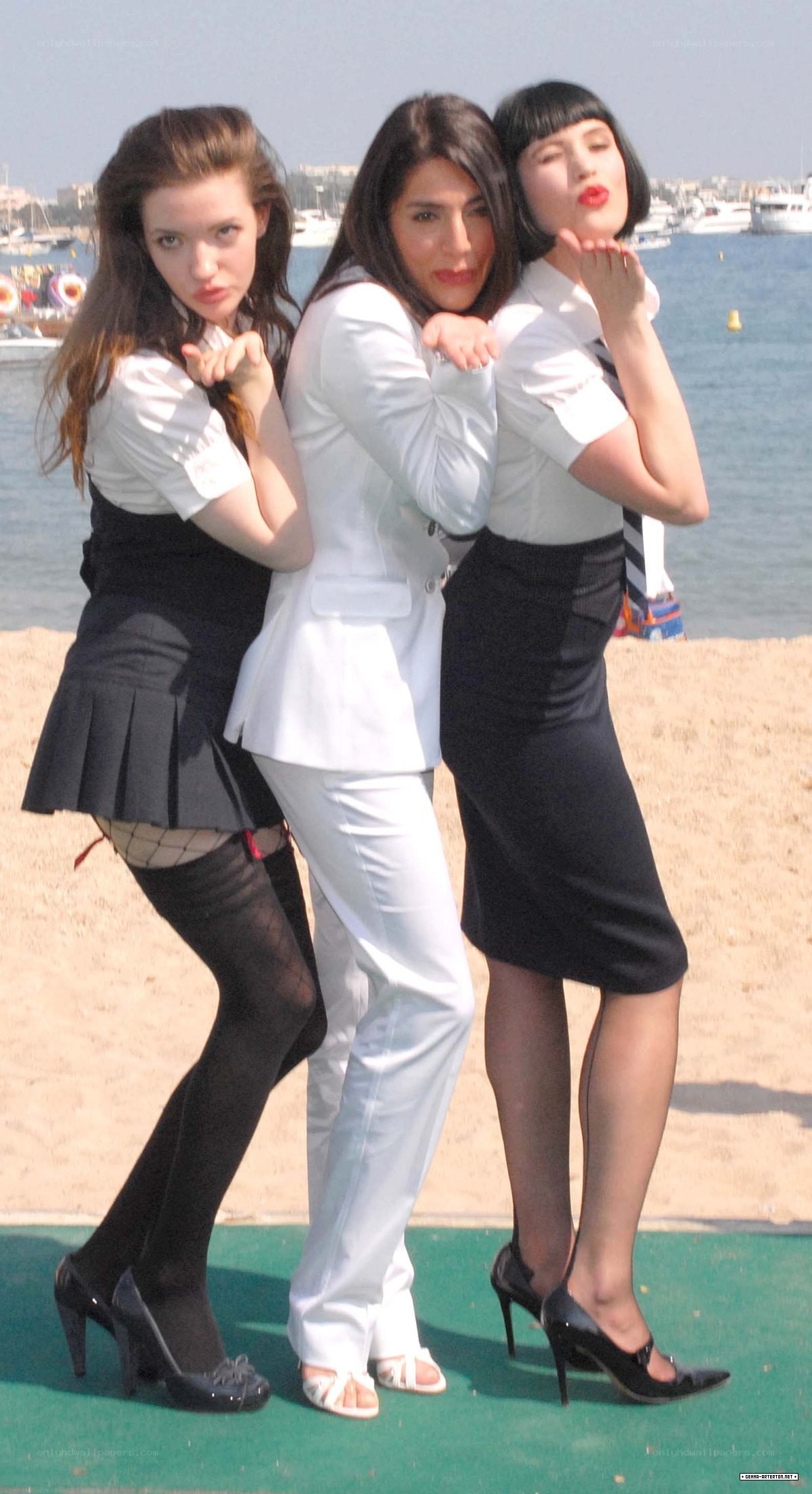 Three women posing on a beach