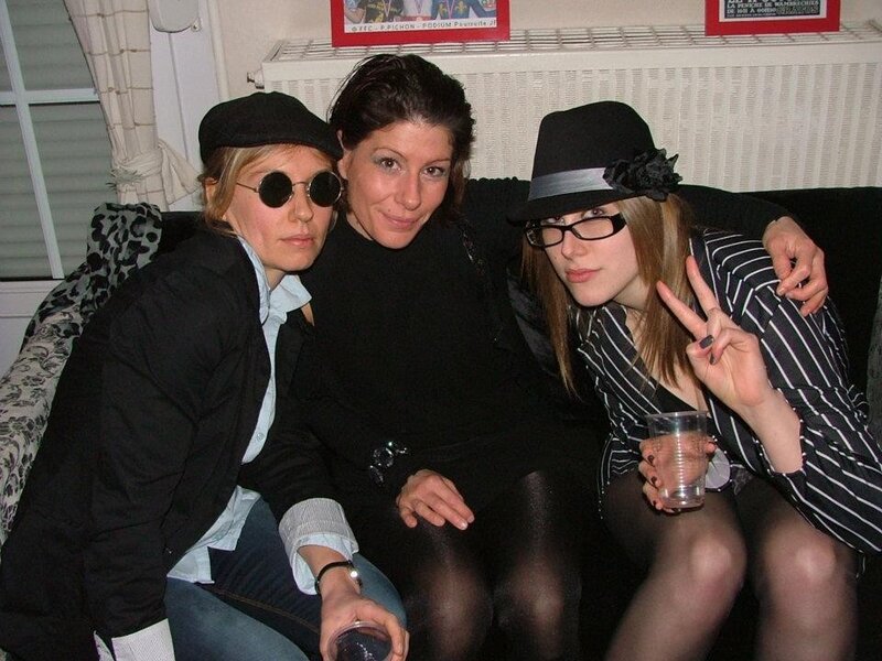Three women posing on a couch