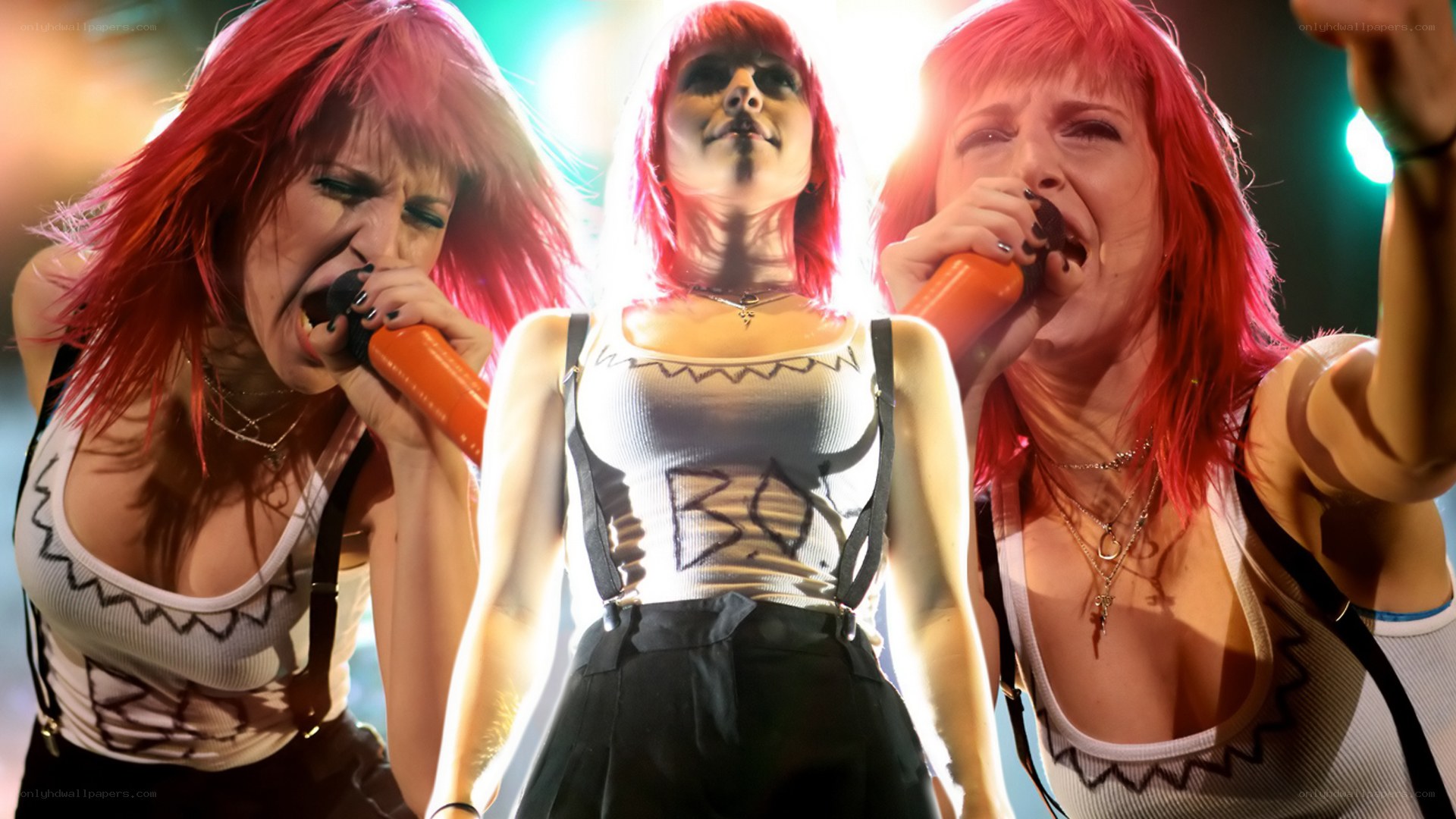 Three women singing on stage
