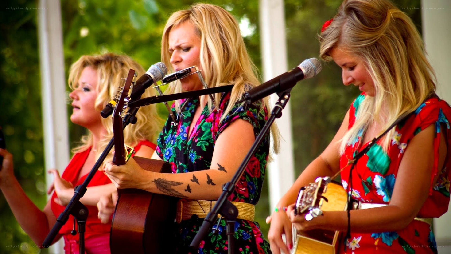 three women singing outdoors