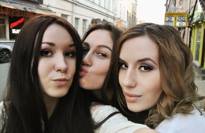 three women taking a selfie on the street