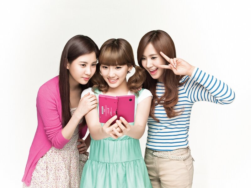 three women using pink tablet